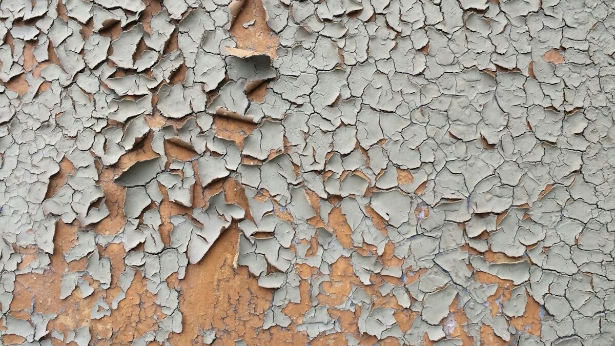 Aged cracked and peeling paint on an older wall